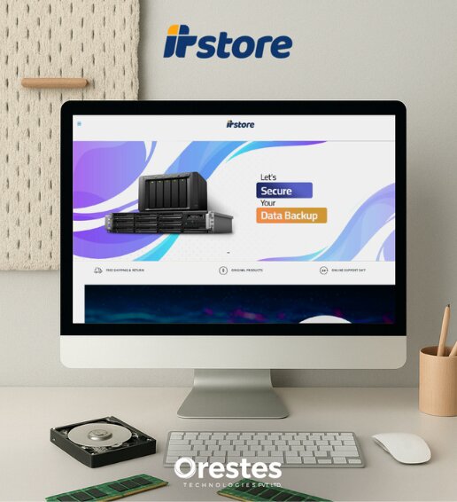 A sleek desktop monitor displaying the ITStore website homepage featuring "Data Backup" solutions, positioned on a clean white desk with a keyboard, mouse, and hardware components.