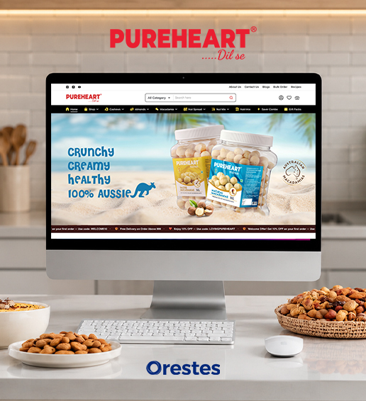 Pureheart website homepage banner featuring Australian Macadamias displayed on a modern desktop computer monitor next to a basket of mixed nuts.