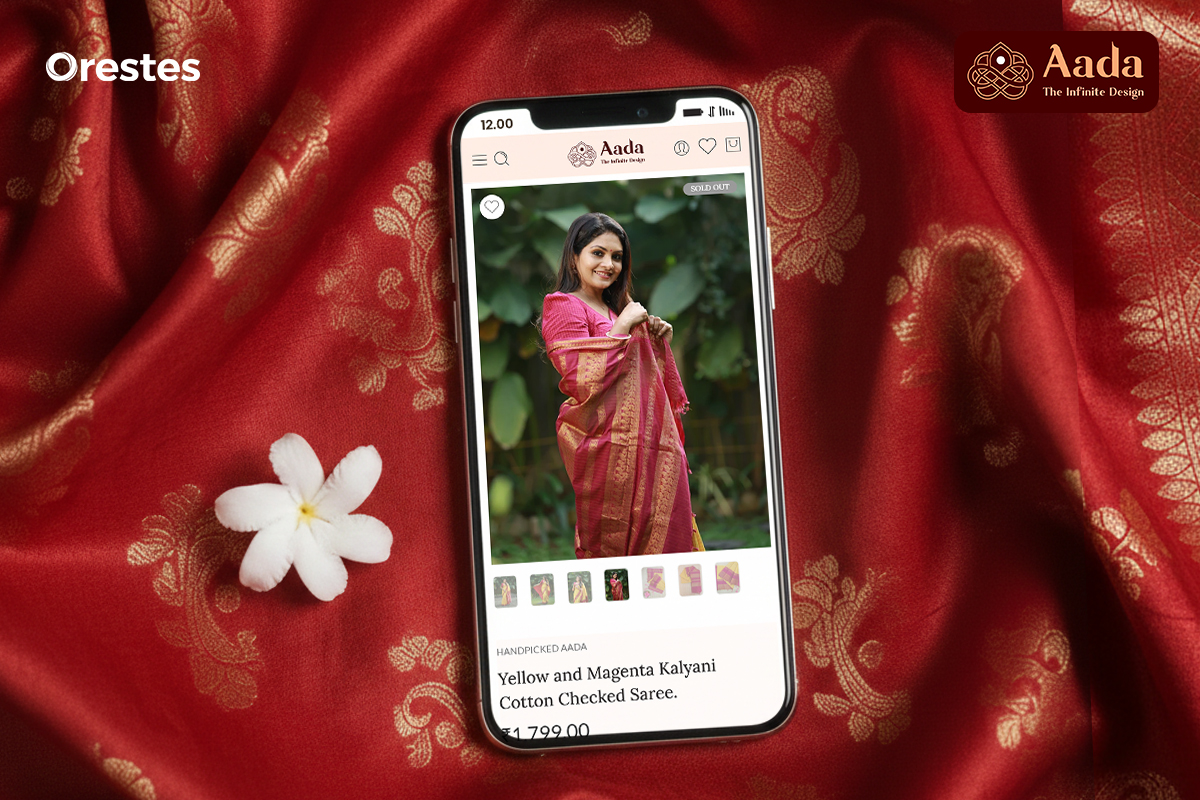 A mobile mockup displaying Aada’s saree product page, set against luxurious fabric textures, emphasizing mobile-first design and smooth browsing for online shoppers.